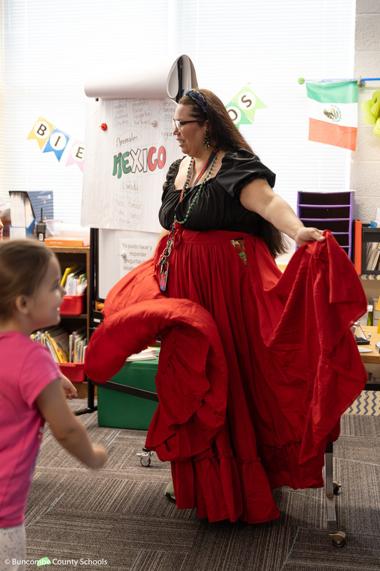 Ms. Esperza showing the students a traditional dance. 