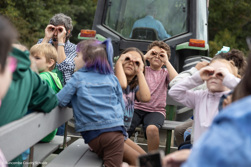 Students trying to spot apples on the tractor ride. 