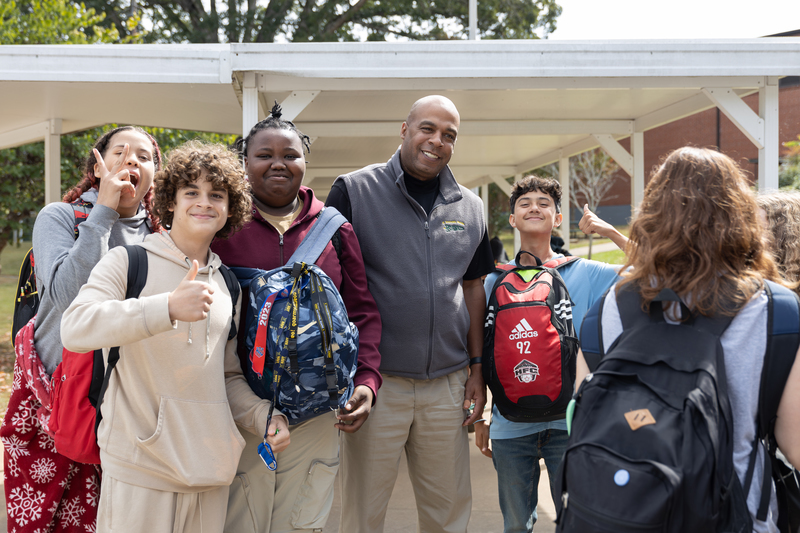 Mr. Wheless with a group of eighth grade students. 