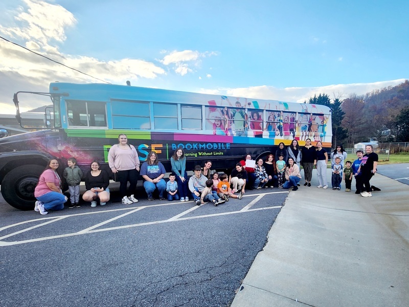DECA students and PreK students in front of the Bookmobile.