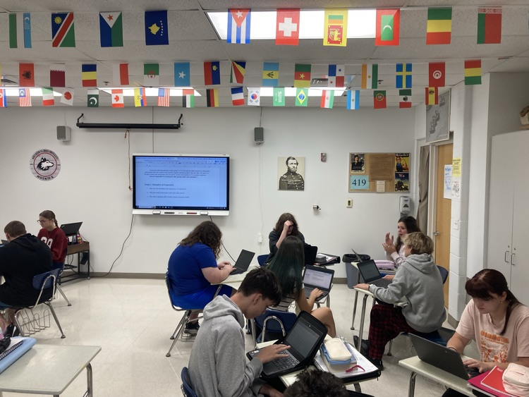 Students collaborate on biosphere assignment. 
