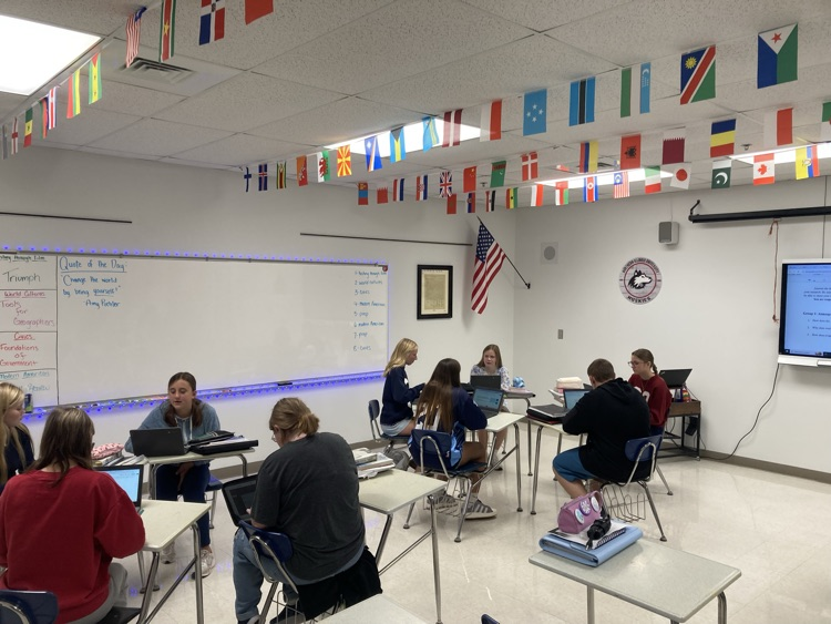 Students collaborate on biosphere assignment. 