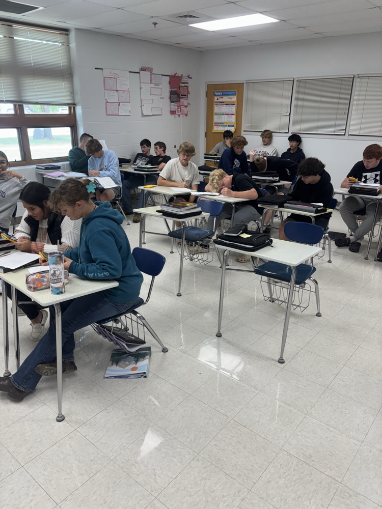 Math 3 students helping each other reinforce and study for an upcoming quiz.