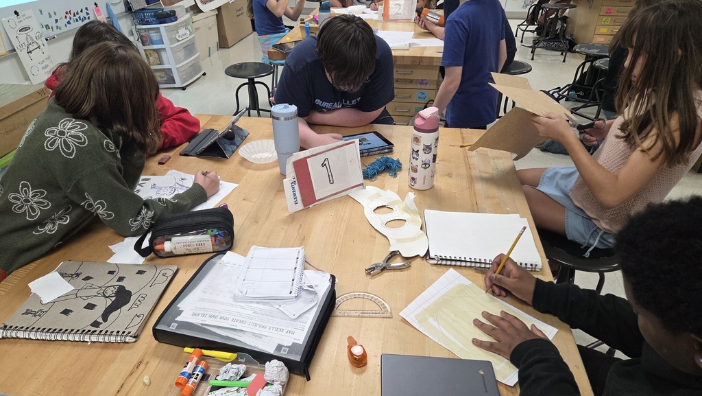 Students working on t-shirt contest designs. 
