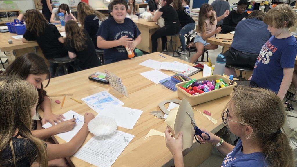 Students working on t-shirt contest designs. 