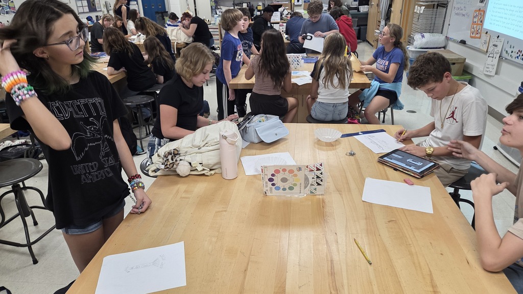 Students working on t-shirt contest designs. 