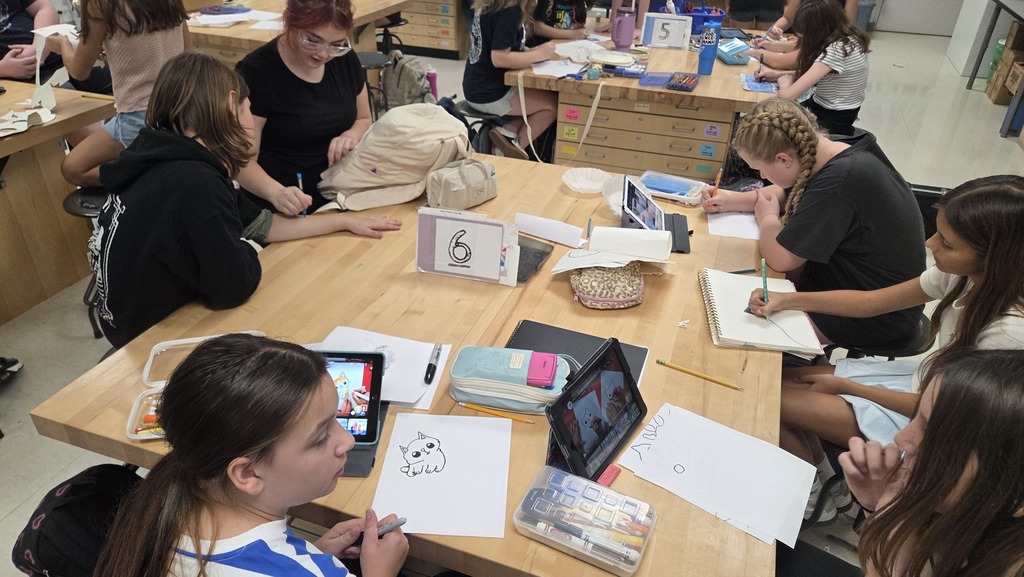 Students working on t-shirt contest designs. 
