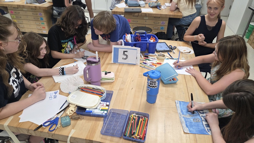 Students working on t-shirt contest designs. 