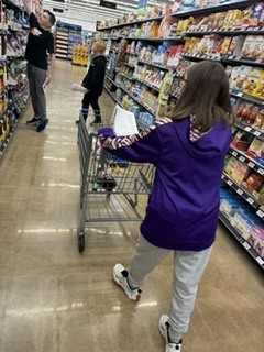 A student is pushing a shopping cart.