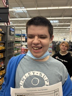 A student is smiling at the camera.