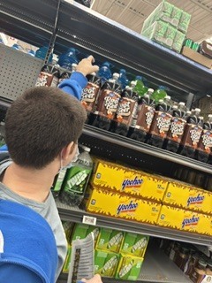 Student is taking an item off a shelf.