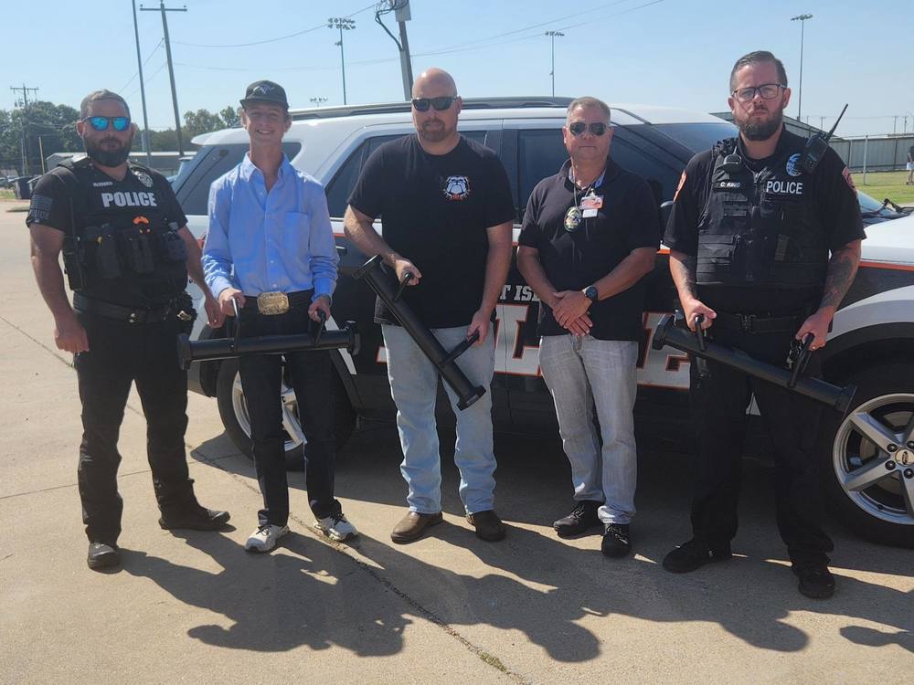 Student's welding ram tools with cops and teacher