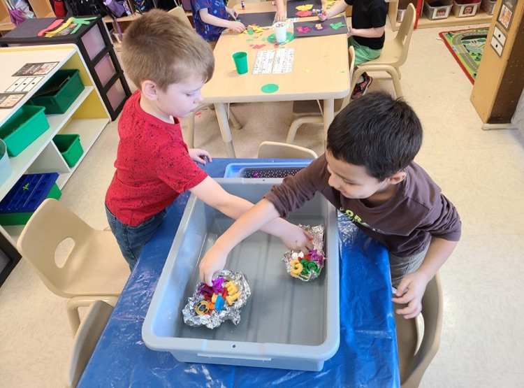 PreK students work on a science project