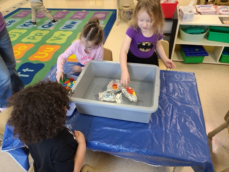 PreK students work on a science project