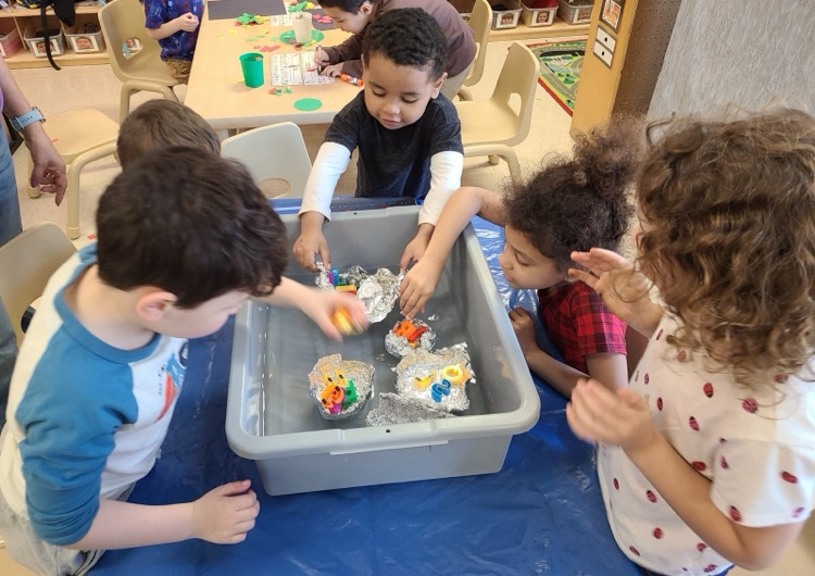 PreK students work on a science project