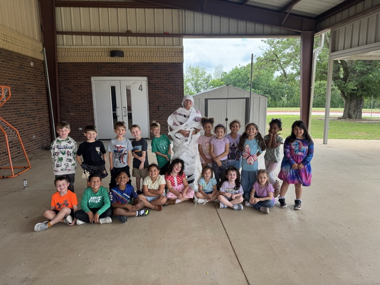 Students made their goal and their teacher got wrapped like a mummy