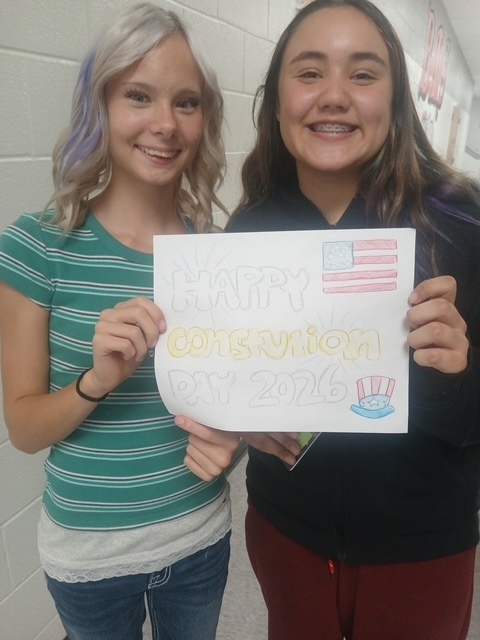 two students with thank you note
