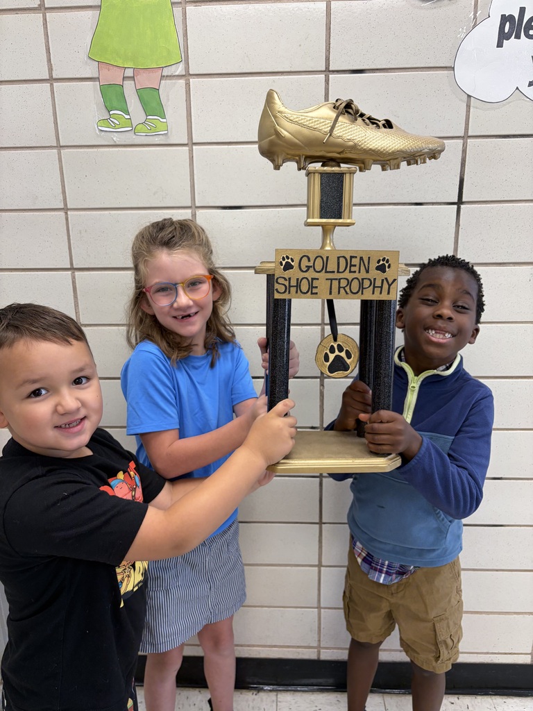 first graders holding the trophy!