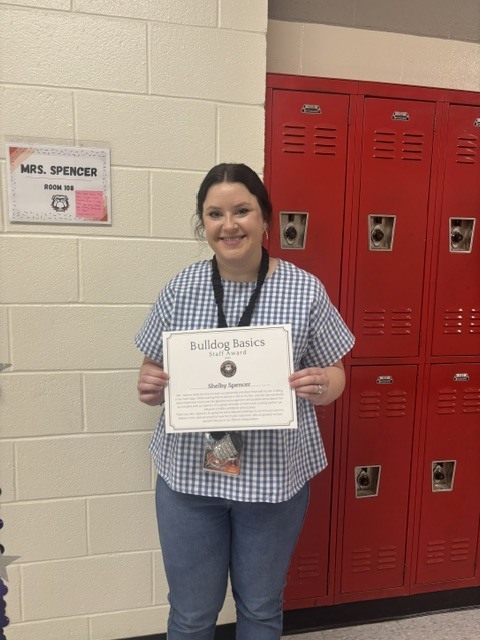 Teacher with award