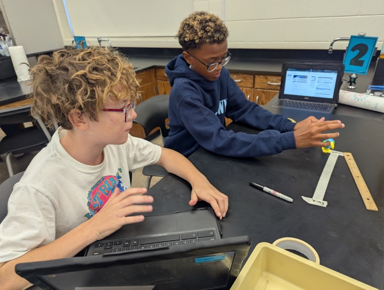 students completing science lab