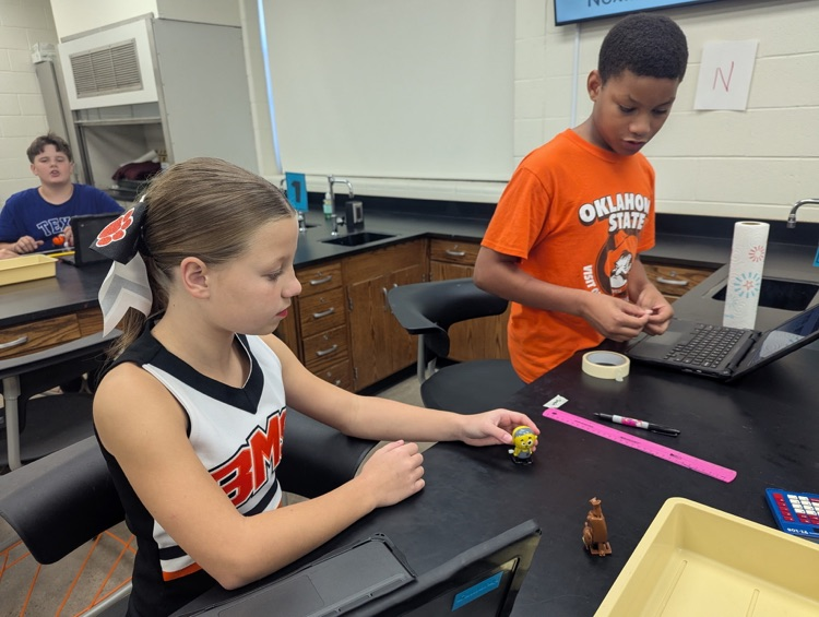 students completing science lab
