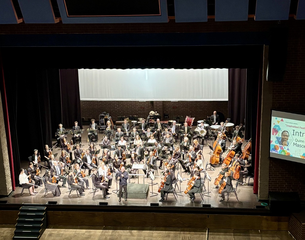 a symphony performs on stage at the COMMA