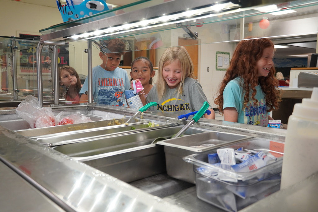 students laughing in the serving line