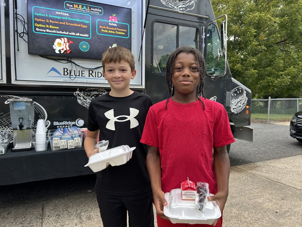 students pose outside of the food truck