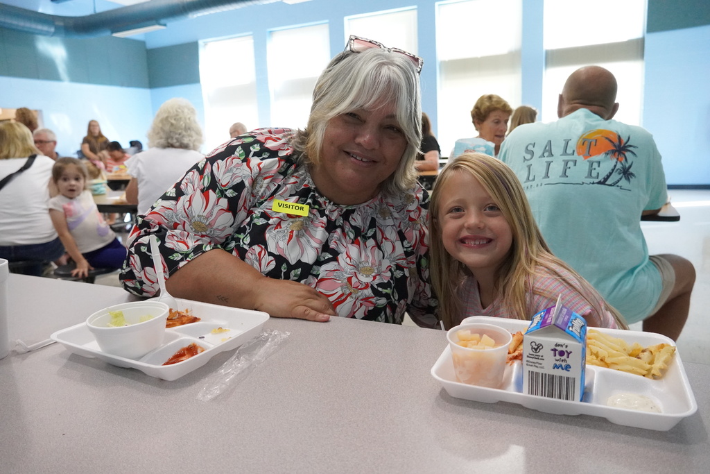 student at lunch with grandparent