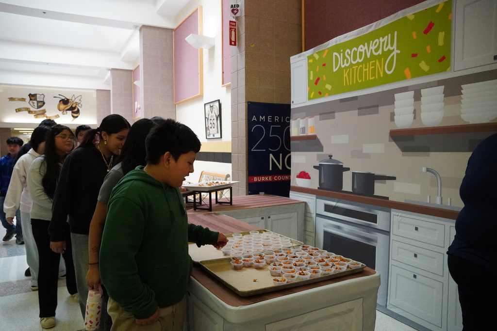 students grab samples from a table setup