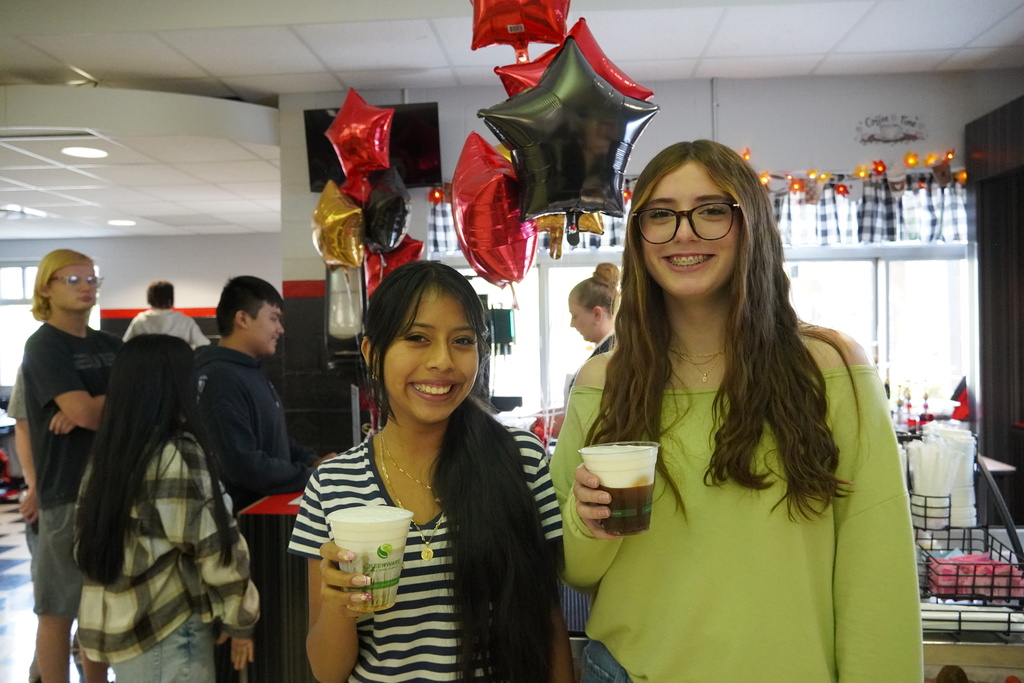 students pose with coffee