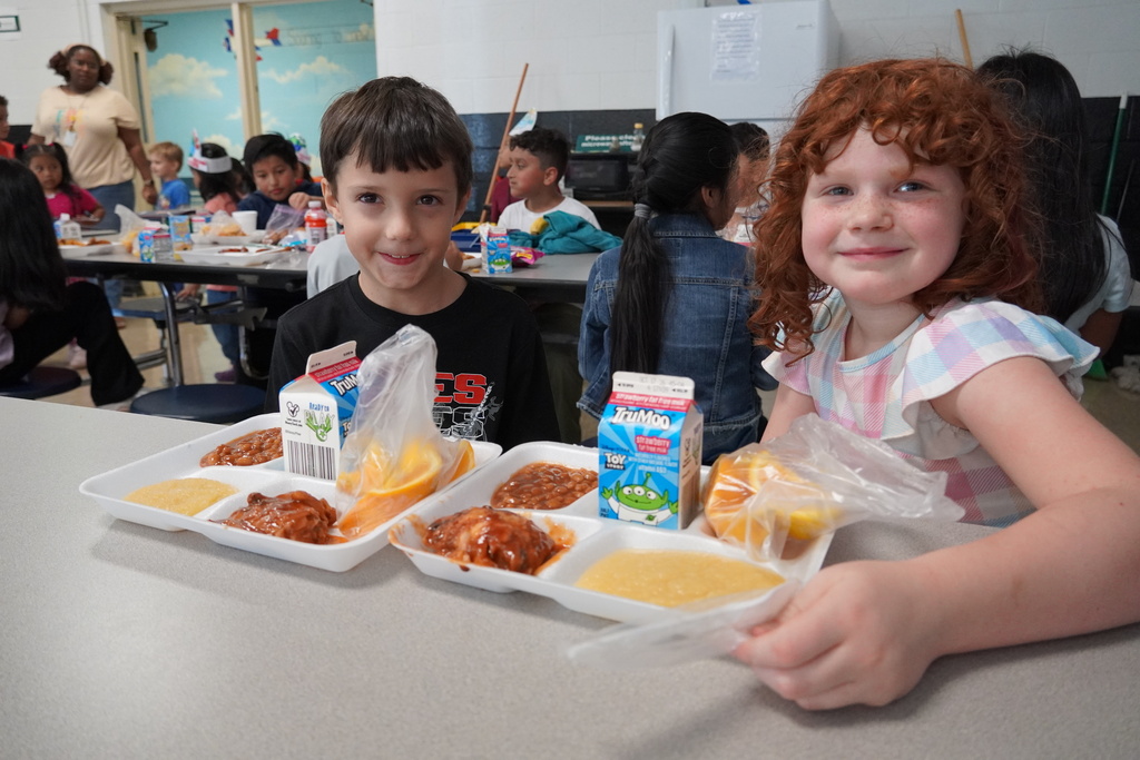 students smiling with lunches