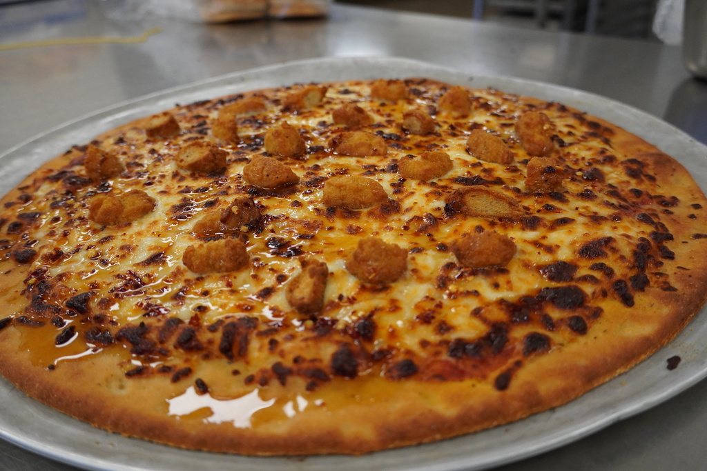 close up of hot honey popcorn chicken pizza