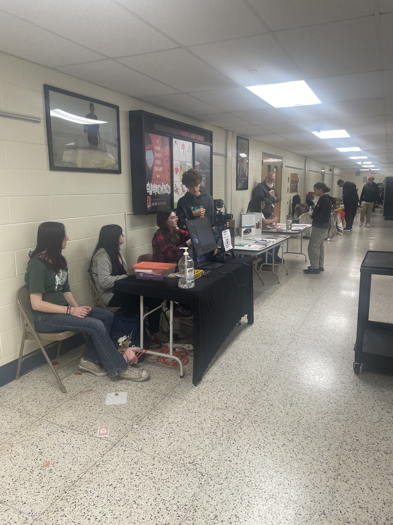 Table with students annual activities fair at medford