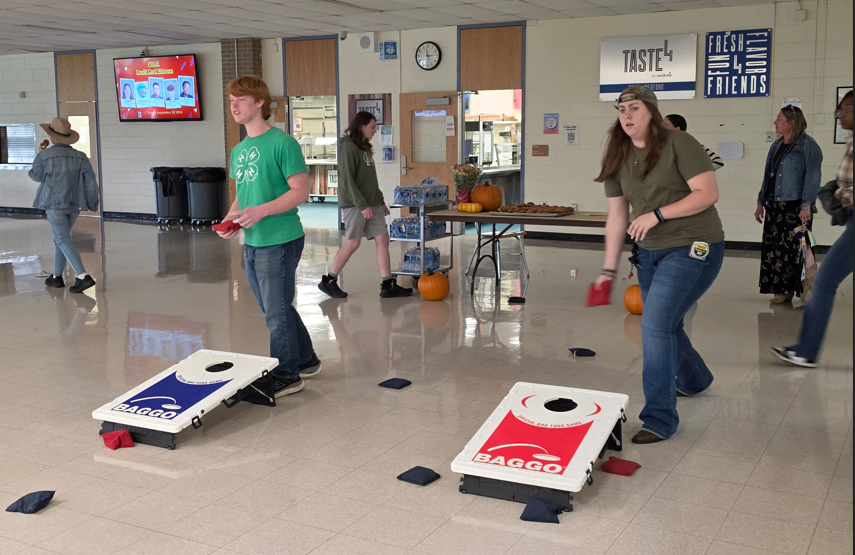 Students playing cornhole