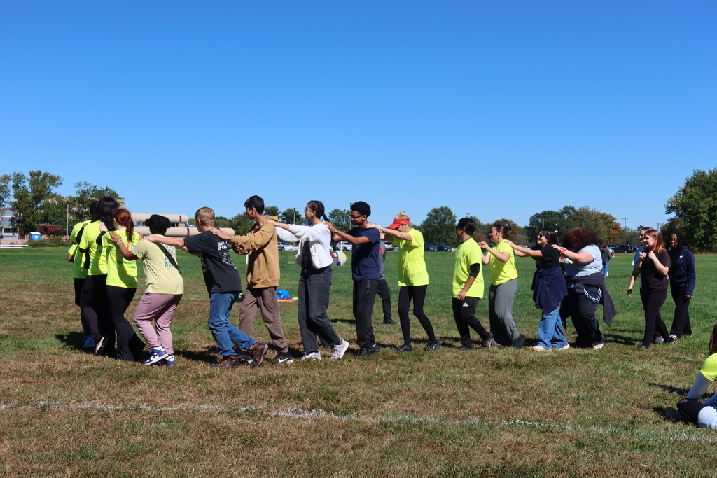Team building activity at medford. students engaged in a hands on activity on the field. 