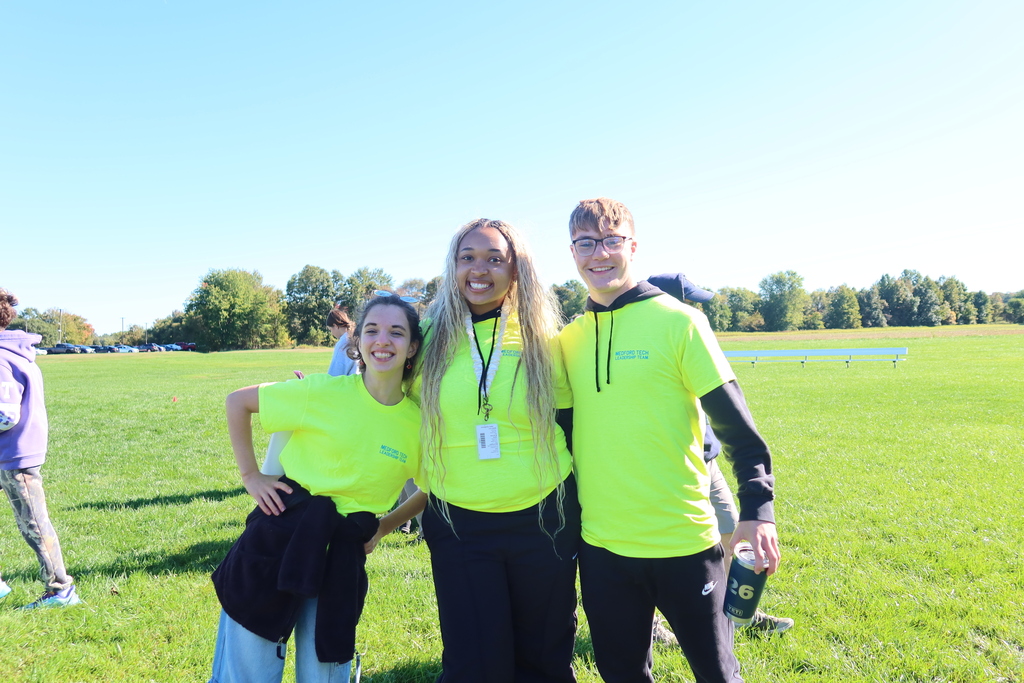 Three students posing. Looks like they are upper classmen.