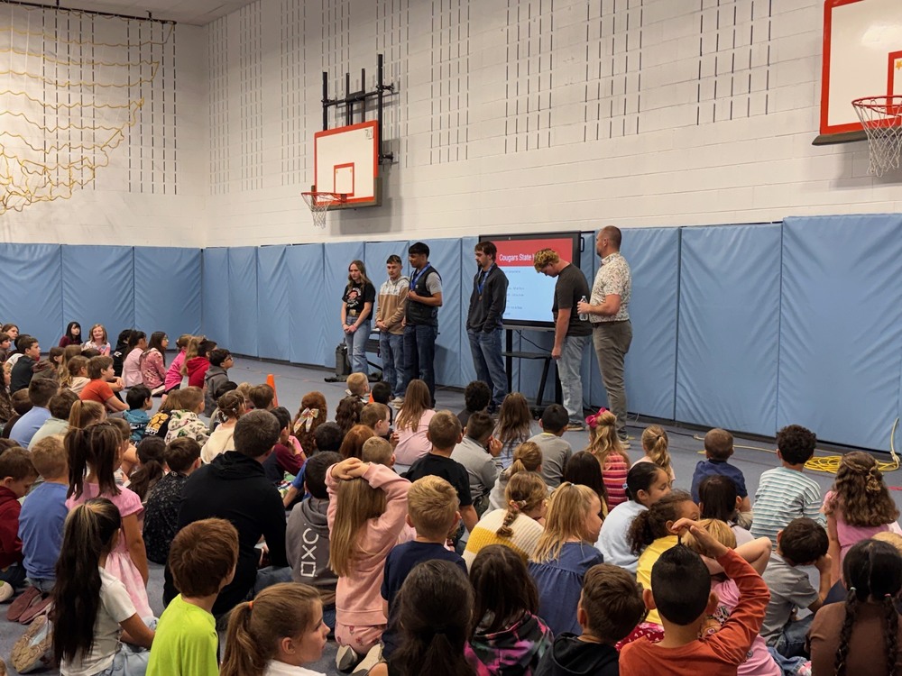Wrestlers speaking at school assembly
