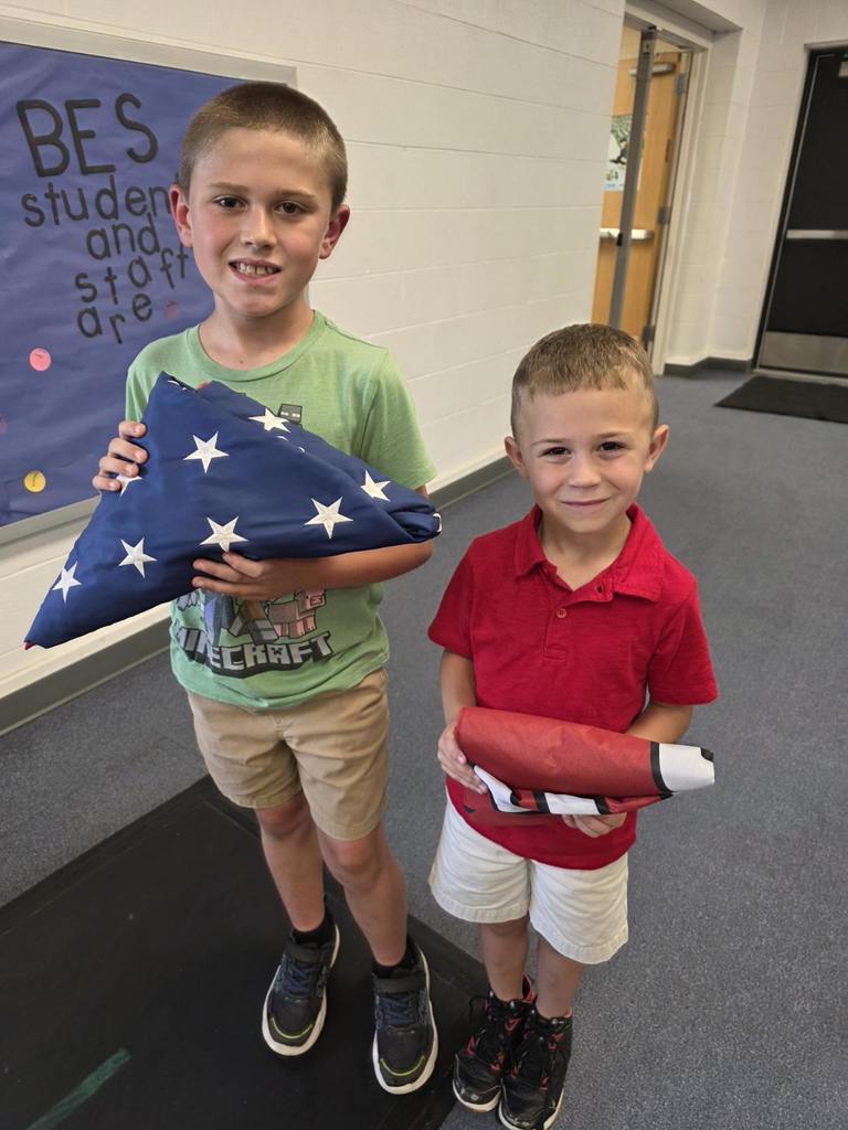 Students showing how they folded the flags.