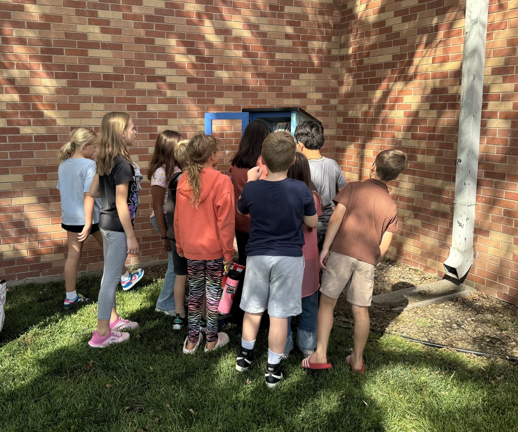 kids looking at the free library