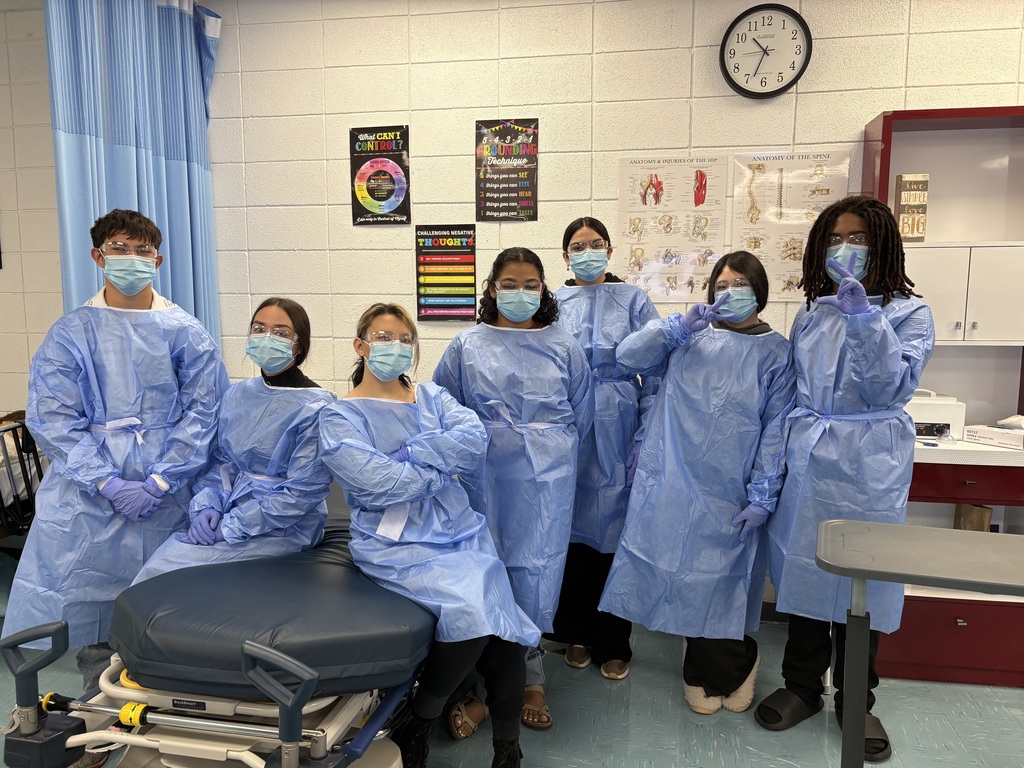 Seven students in medical protective gear.