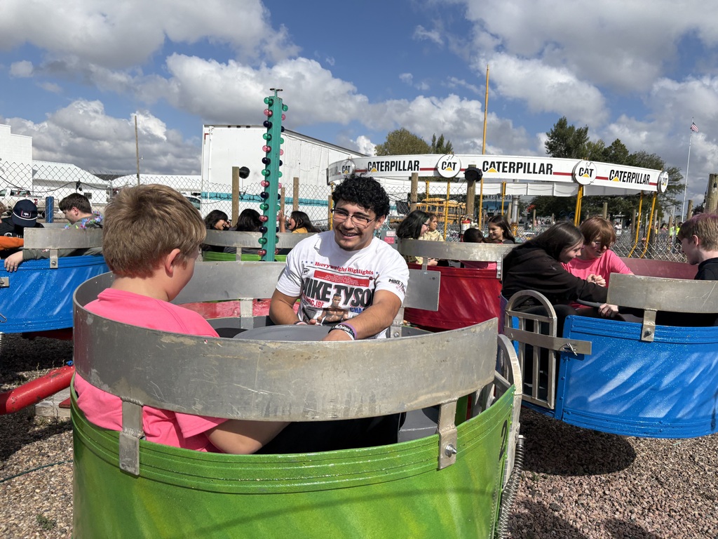 Students riding on a carnival ride.