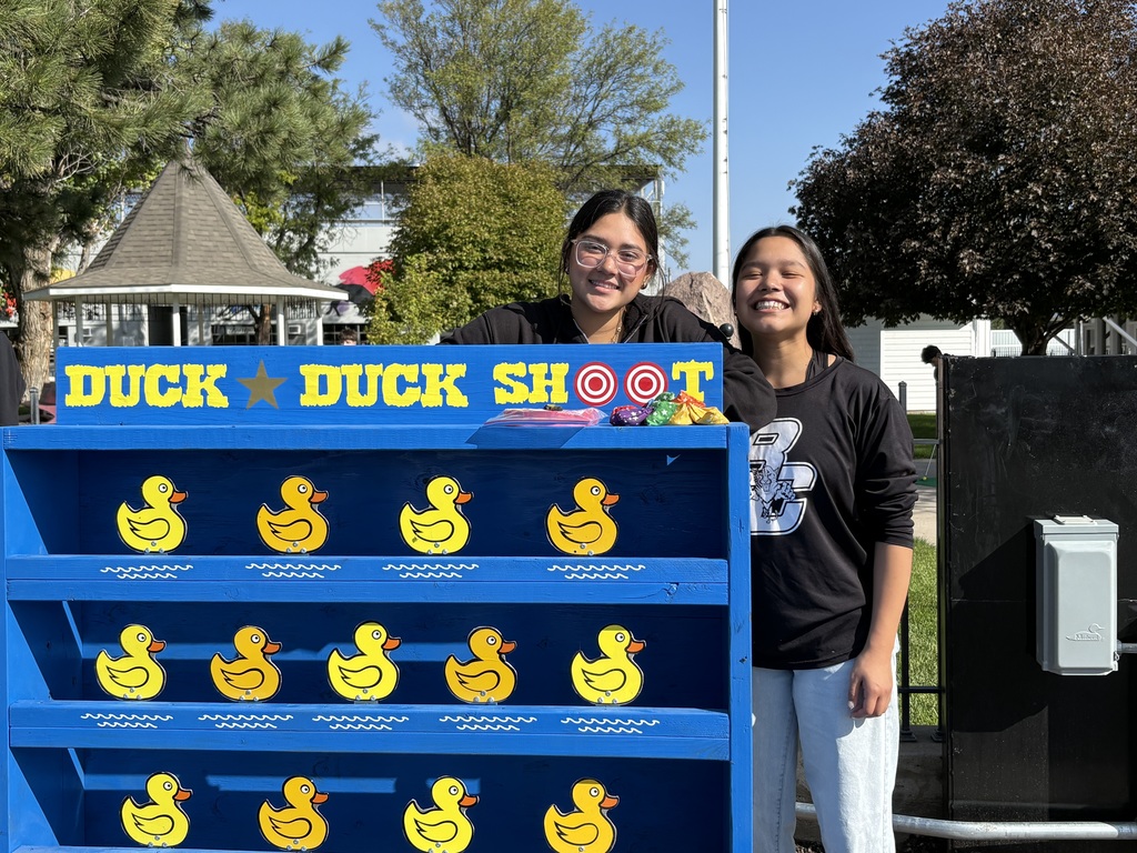 Students posing with a carnival game.