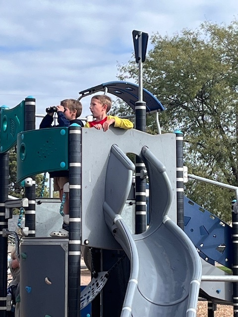 Students using their binoculars at recess.