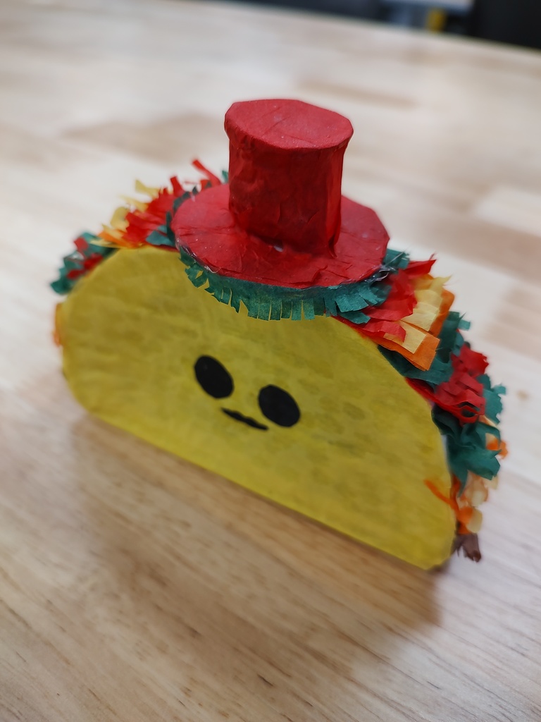 A mini pinata in the shape of a taco.