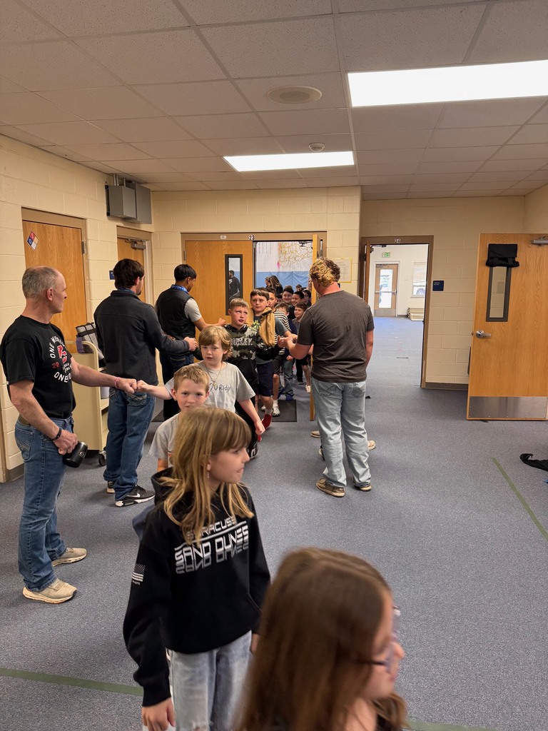 wrestlers hand fiving as kids walked out of the assembly