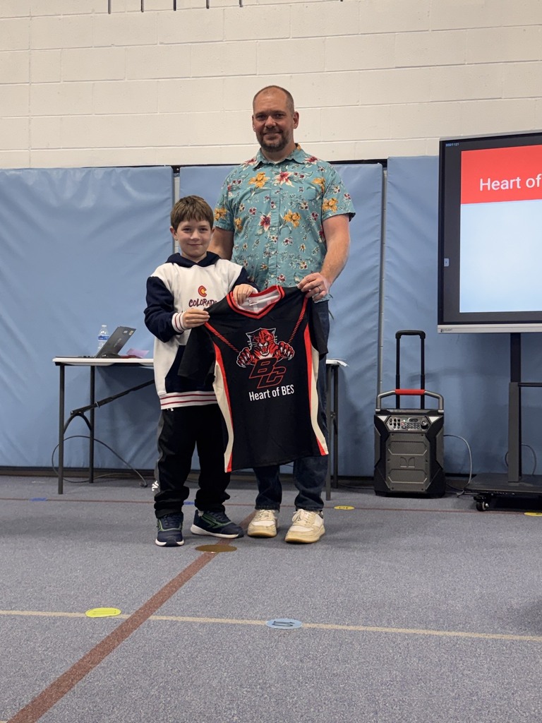 Principal and student getting award.