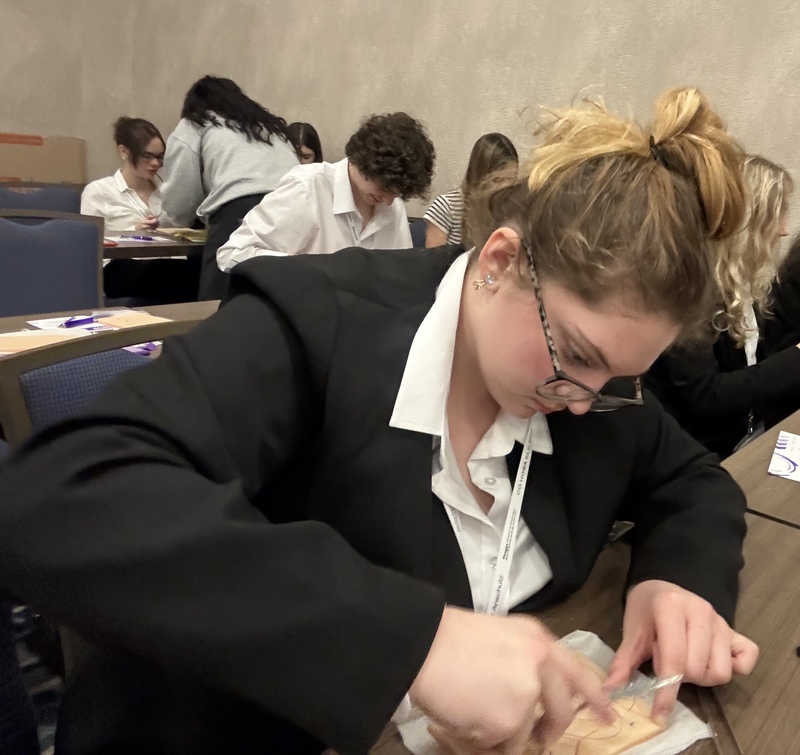 HOSA student practicing suture technique