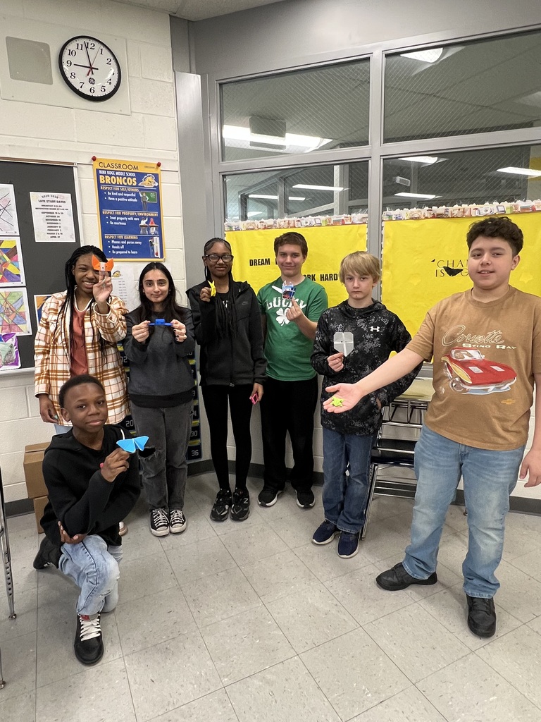 8th grade students making origamis