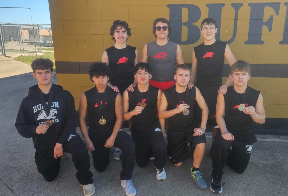 Group of boys posing with medals
